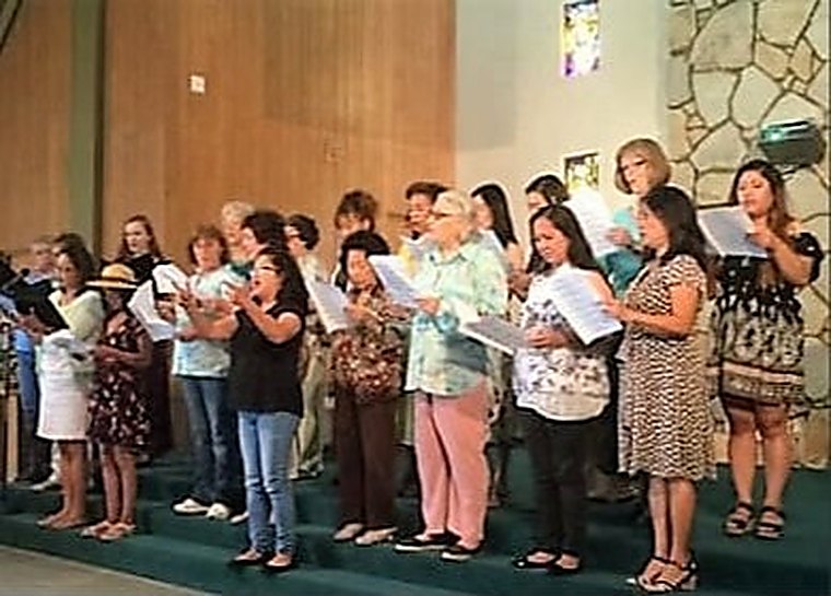 The choir singing together at the front of the St. Mark's sanctuary