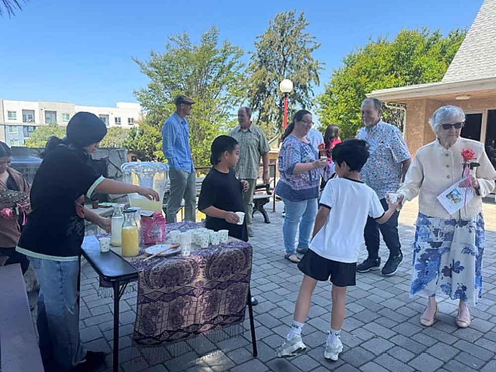 Members of St. Mark's serving food and drinks to neighbors and one another on the church patio