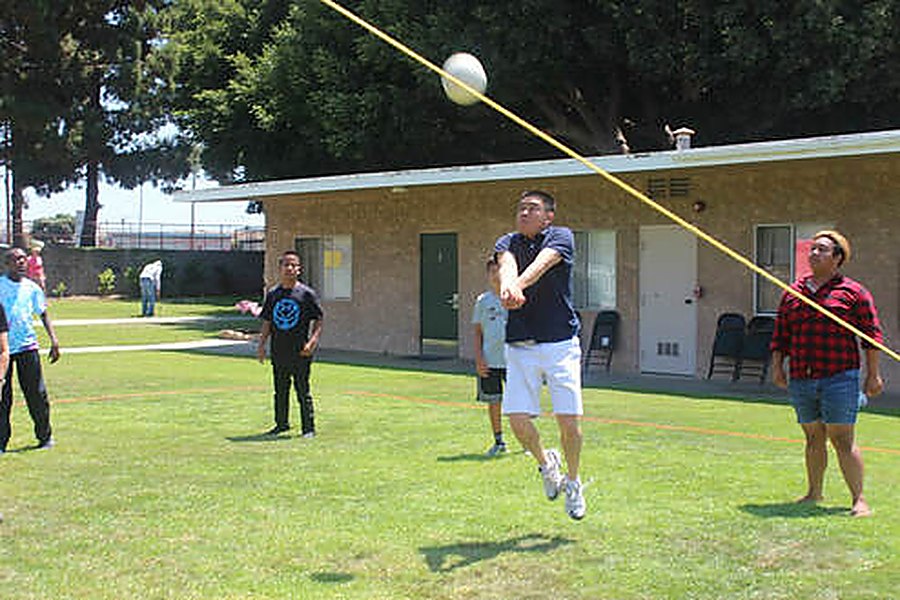 Youth playing volleyball on the church lawn